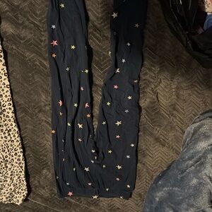 Girls leggings, 1 is blue with colored stars the 2nd is white/cream with cheetah